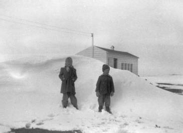 Benson County Pleasant Lake 1952-53 - Mark J. Halvorson Janice and Byron Halvorson near the only snowbank on their farm in rural Pleasant Lake Township