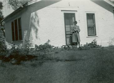 McKenzie County 1930 - Pioneer Museum of McKenzie County Collection - Woman outside home 