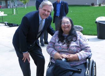 Minot - Linda S. pictured with Sen. Hoeven at Washington Townhomes. Linda lost her home to the 2011 Souris River flood.
