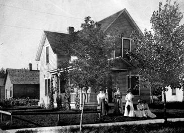 Bismarck 1900 - ND Oral History Project Photograph Collection - John F. Youngman and five women in front of residence on corner of Rosser and 2nd St.