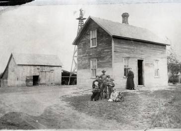 Scranton - Photo of a farm house, barn, windmill, and the Pierce family in front of their home - Dickinson Museum Center