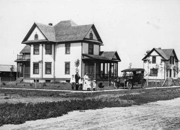 Family in front of a house on a corner