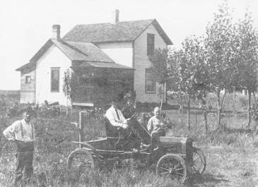 Man in a car in front of a house